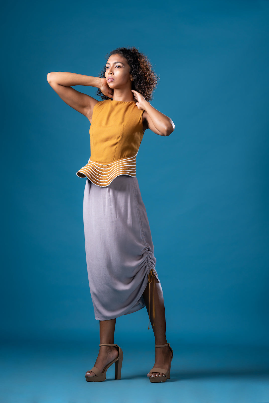 French Ochre Backless Peplum Top With Sepia Grey  Asymmetric Skirt - Khushboo Haran Borkar